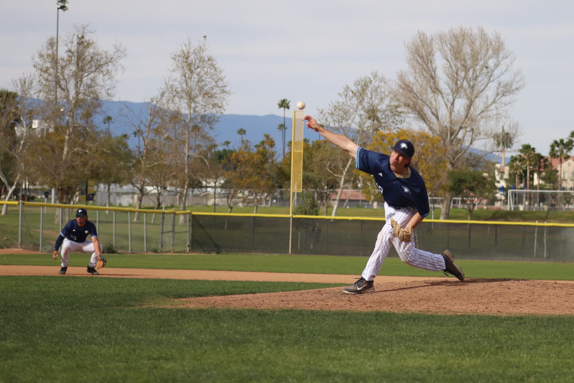 Jake Discount pitching for his college baseball team